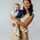 Woman holding a baby in a beige EMF protective blanket Leblok