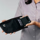 Person placing a phone in Faraday bag from Leblok Security